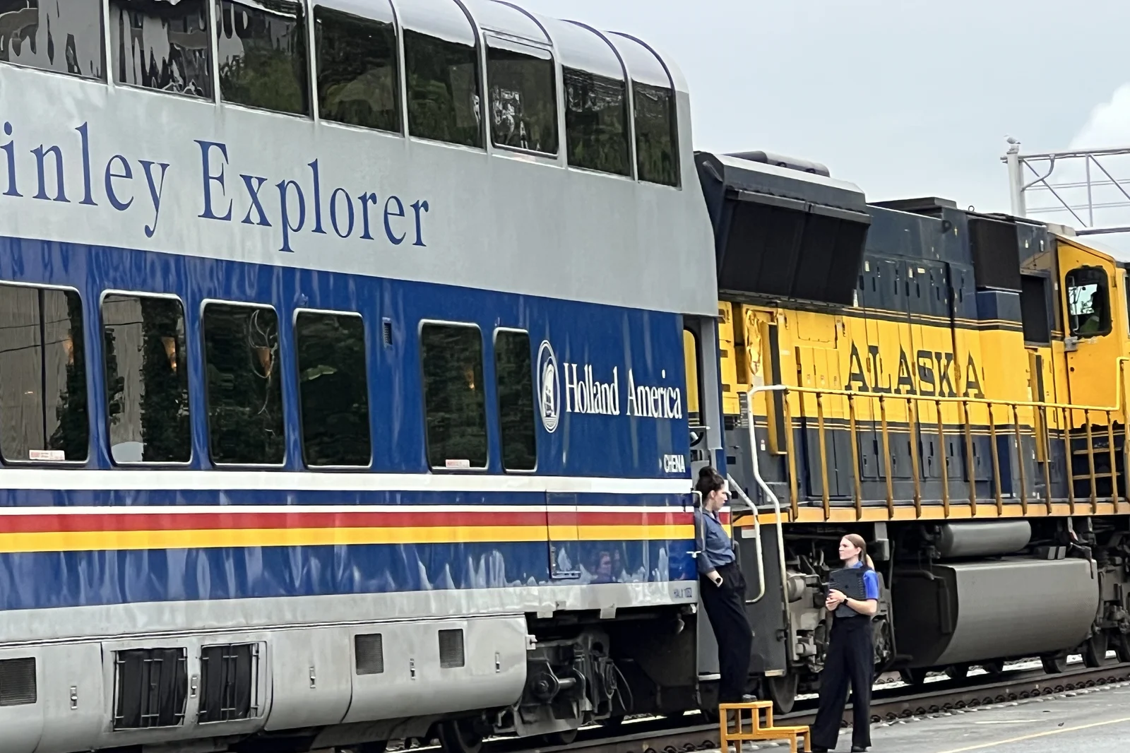 A Holland America McKinley Explorer glass-dome rail car coupled behind an Alaska Railroad locomotive