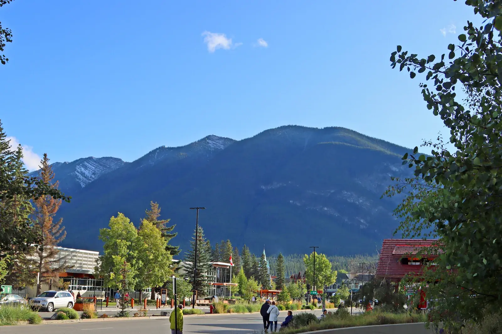 The main street of Banff townsite on a clear day with Cascade Mountain rising behind it