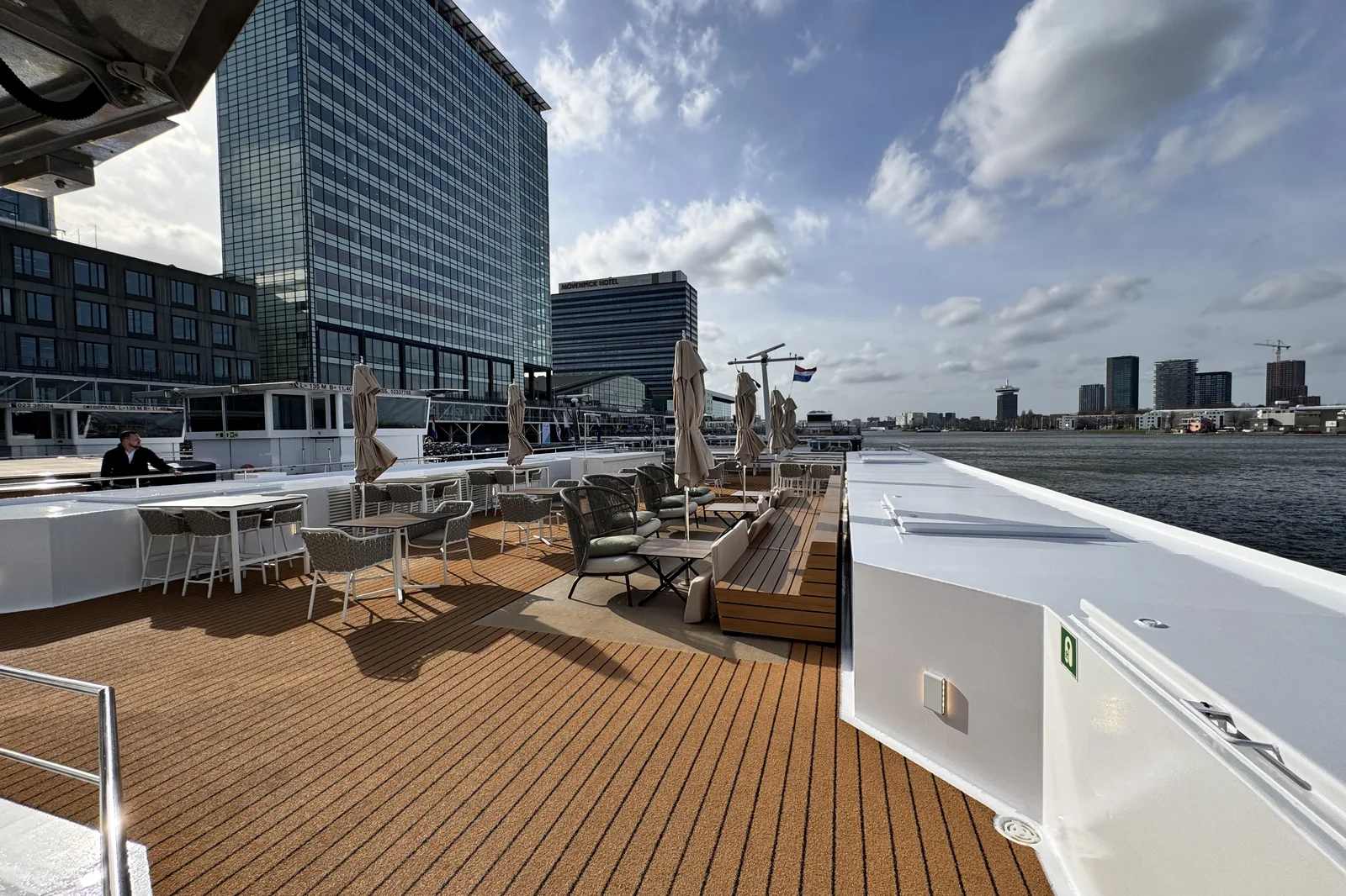 The sun deck of a river ship moored in the middle of a European city