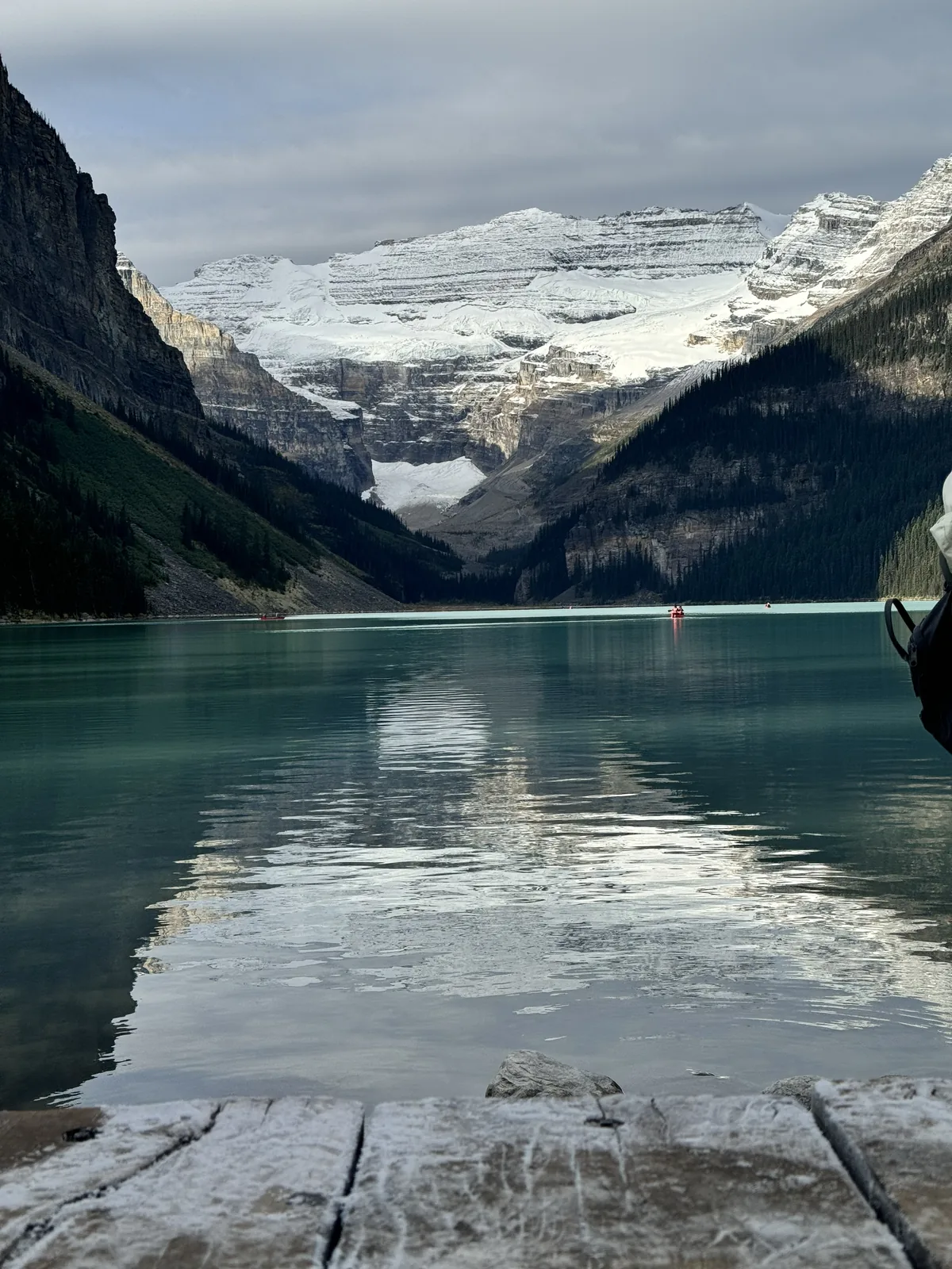 Lake Louise in Banff, snow-capped peaks reflected in turquoise water, a stop on a Rocky Mountaineer land tour.