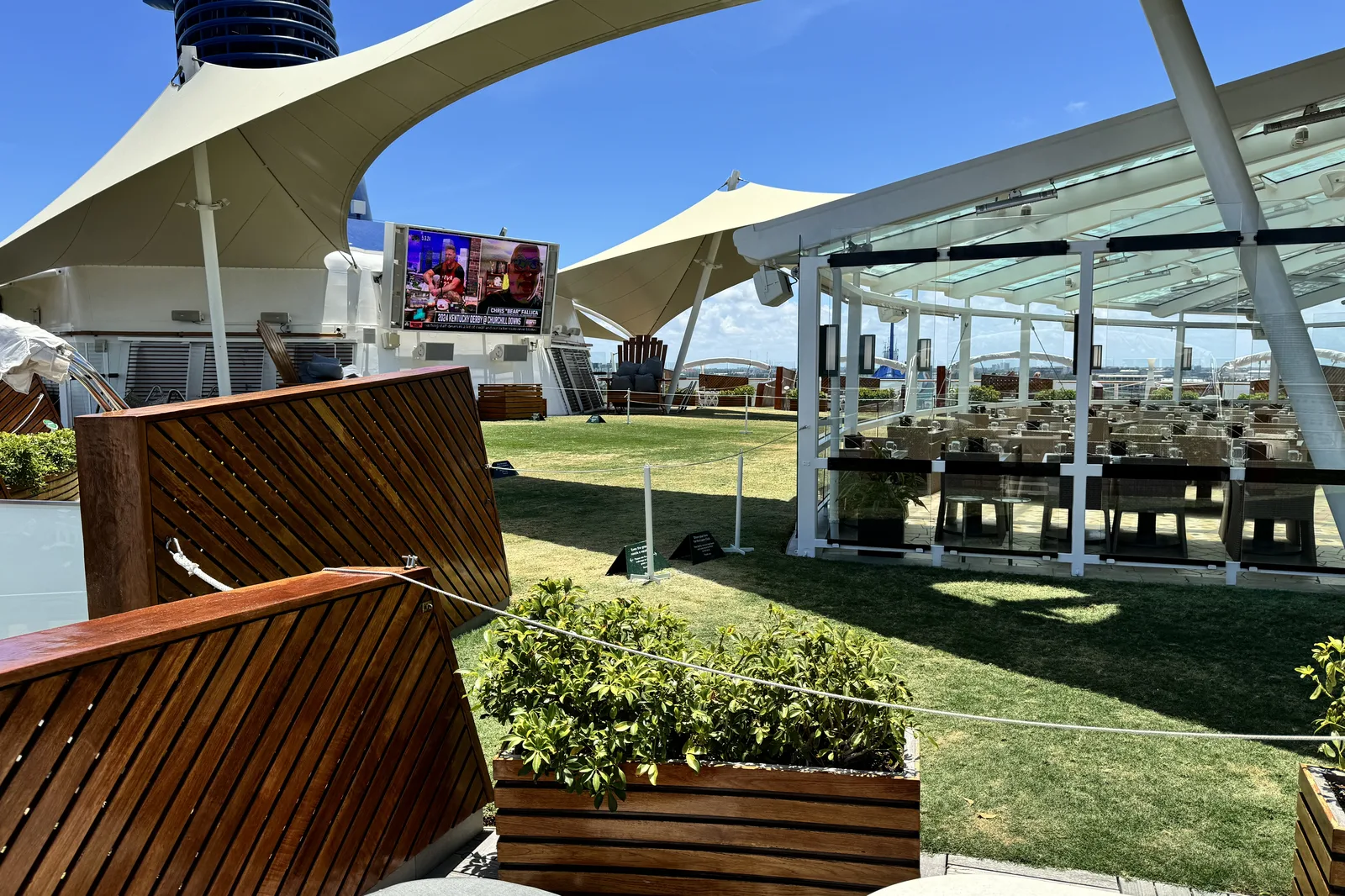 The Lawn Club on Celebrity Reflection, real grass on the top deck under white sail canopies
