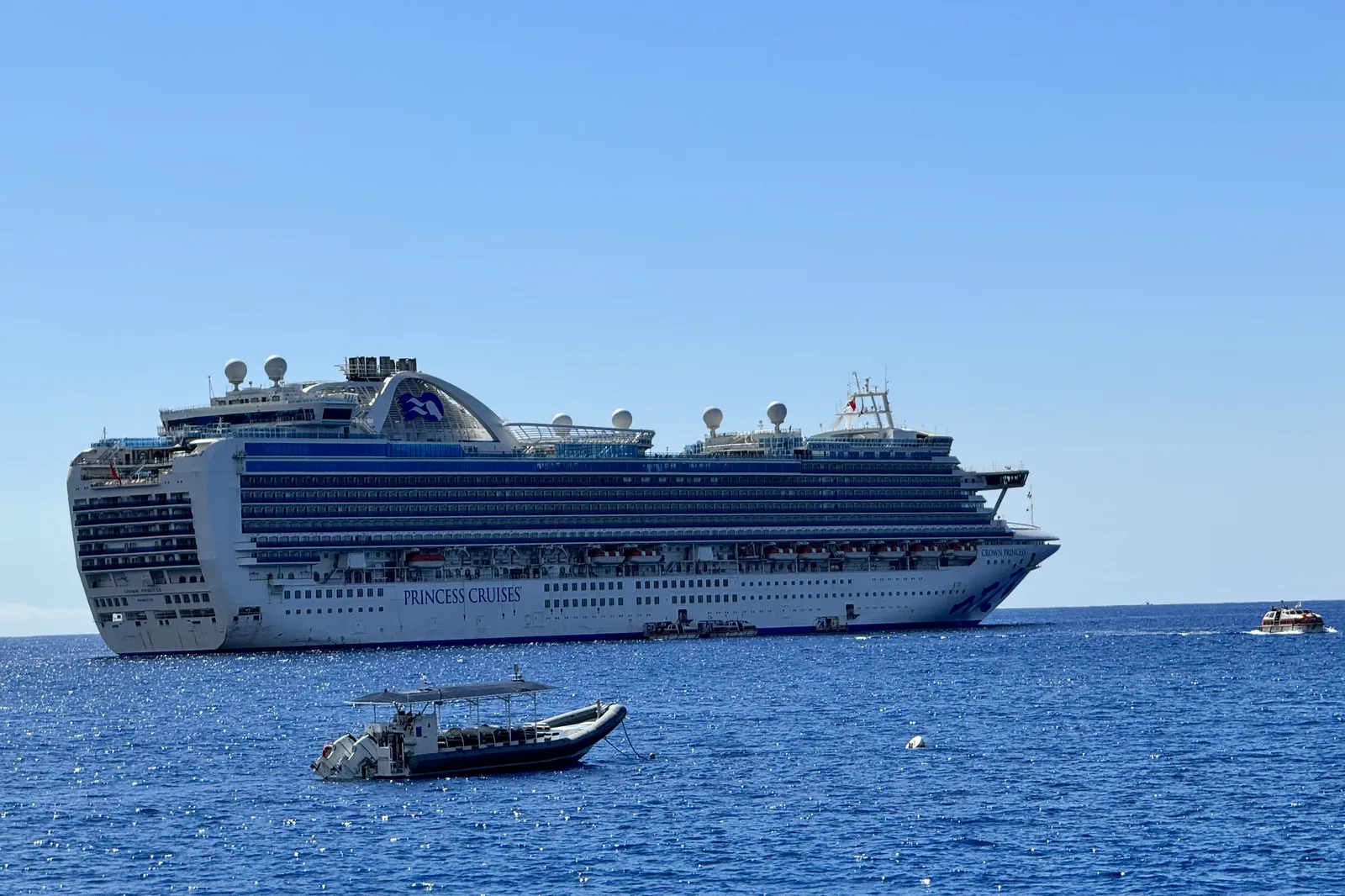Crown Princess anchored off Kailua-Kona on Hawaii's Big Island, with a tender boat heading to shore