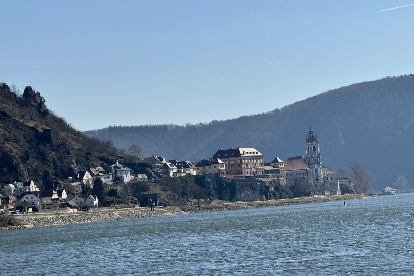 The village of Durnstein on the Danube in the Wachau Valley, its blue baroque abbey tower and hillside castle ruins above the river